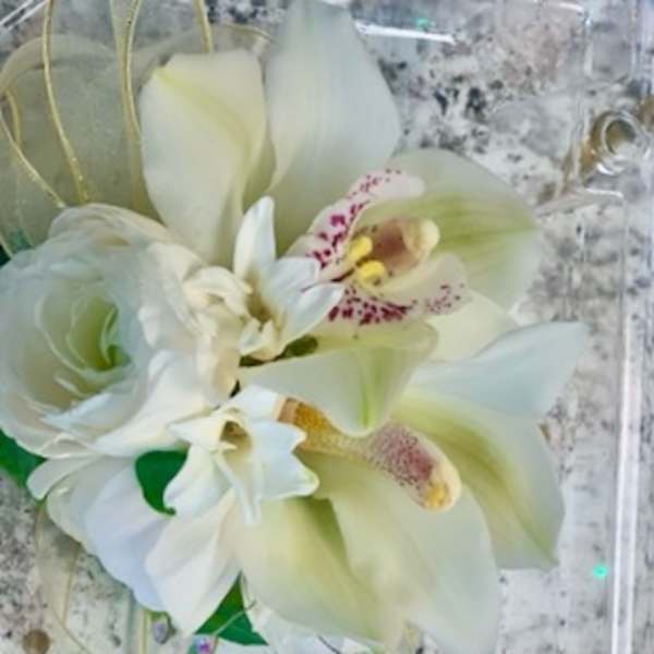 White orchid and calla lily bouquet with green accents