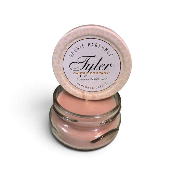 Pink scented candle in a glass jar with a lid
