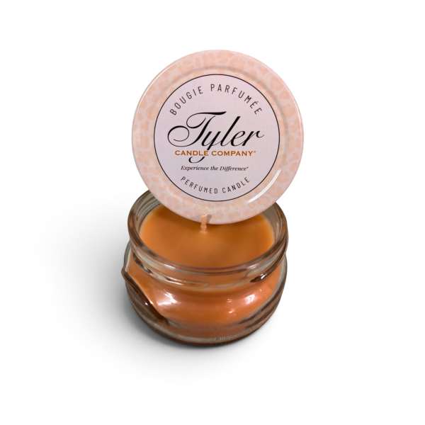 Orange candle in a glass jar with a round lid