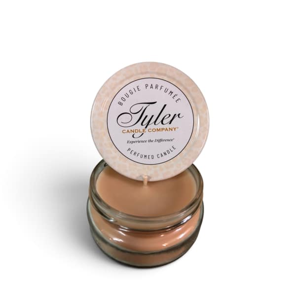 Small scented candle in a glass jar with a round lid label