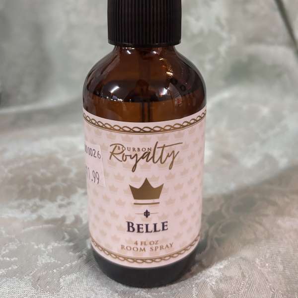 Amber room spray bottle with a black pump and pink label