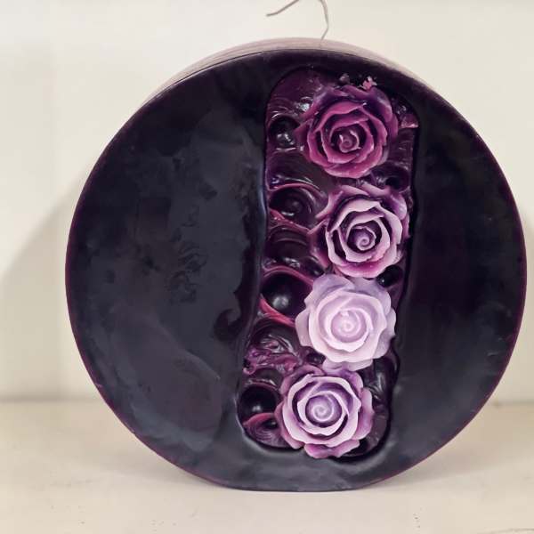 Round dark purple decorative piece with four purple roses