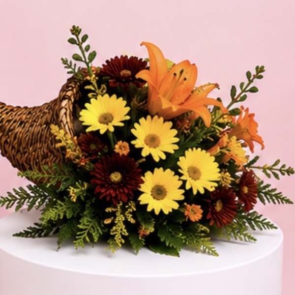 Bouquet of yellow daisies and orange lilies with a woven turkey decoration