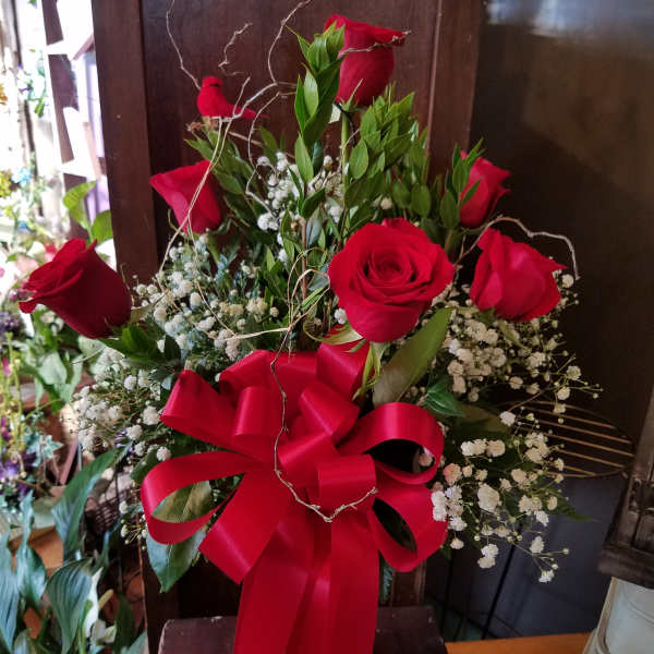 Red roses with baby's breath and a large red ribbon