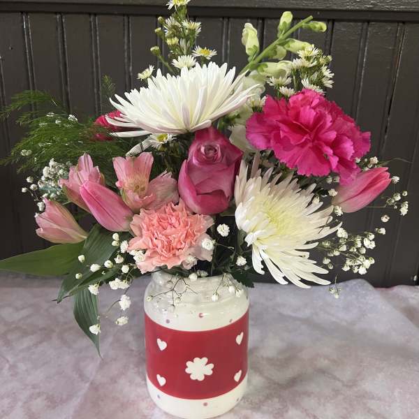 Pink and white mixed bouquet in a decorated ceramic vase
