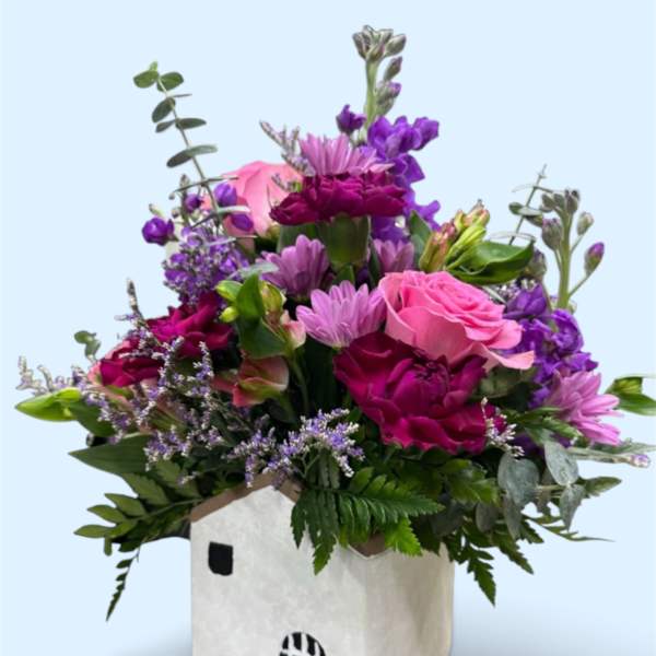 Pink and purple mixed bouquet in a white square container