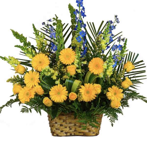 Yellow gerberas and roses with blue flowers in a woven basket