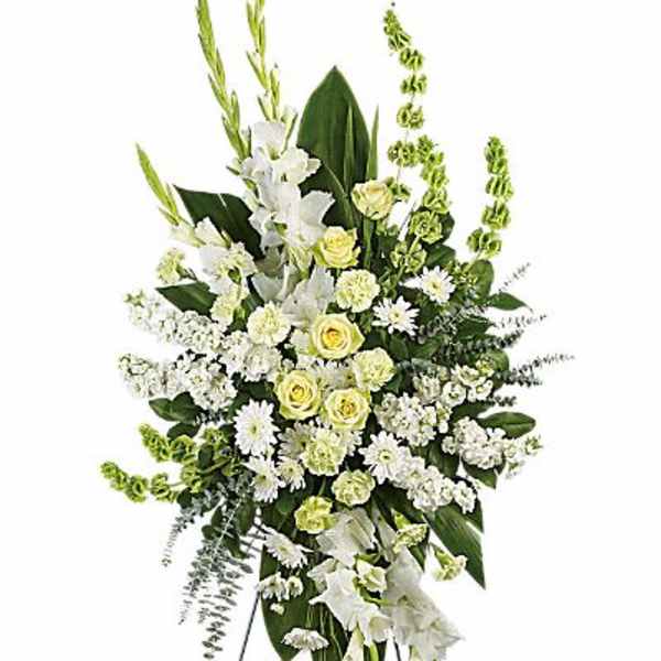 White and pale yellow funeral spray on a standing easel