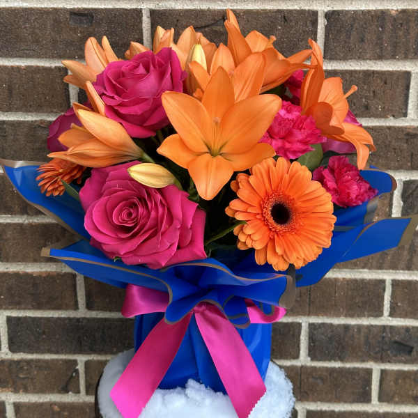 Bouquet of pink roses and orange lilies with a gerbera daisy