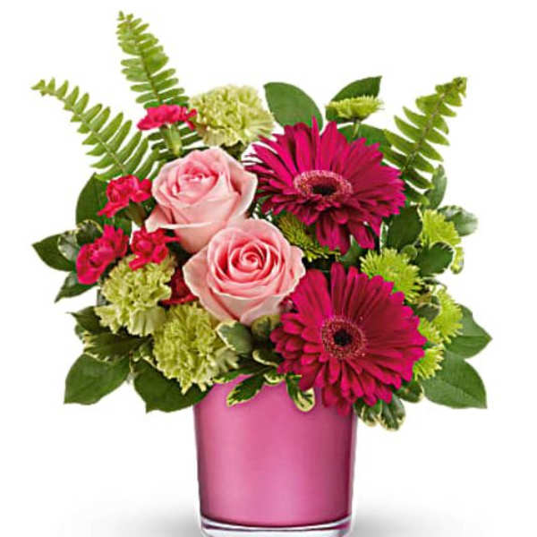 Pink roses and magenta daisies in a pink glass vase