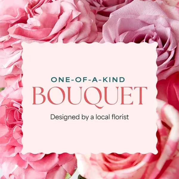 Pink roses surrounding a centered bouquet label