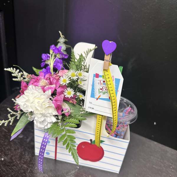Small mixed bouquet in a gift box with a tag and ribbon