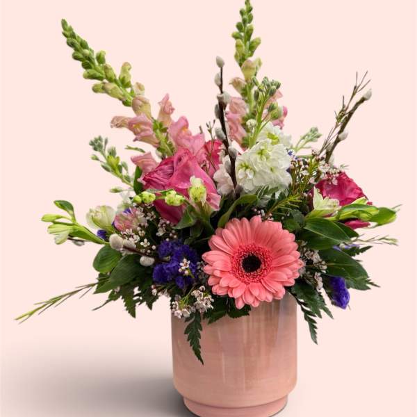 Pink and white mixed bouquet in a blush ceramic vase