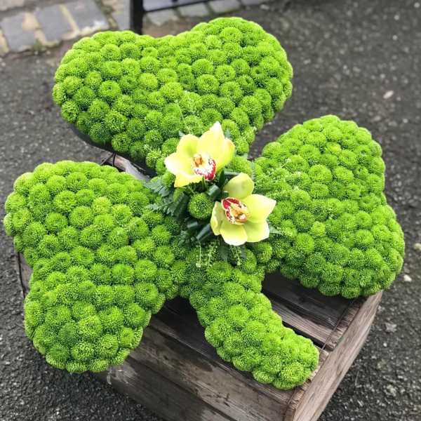 Green chrysanthemum arrangement shaped like a butterfly with yellow orchids