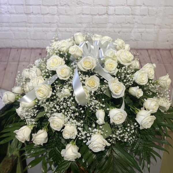 Large white rose arrangement with baby's breath and silver ribbon