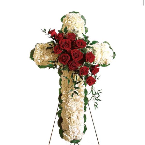 Cross-shaped floral tribute with red roses and white carnations