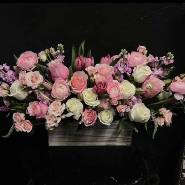 Pink and white floral arrangement in a rectangular wooden container