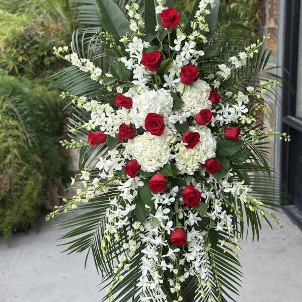 Tall floral spray with red roses and white flowers