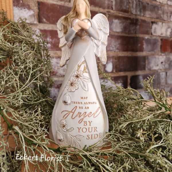 Angel figurine holding a heart with a memorial message