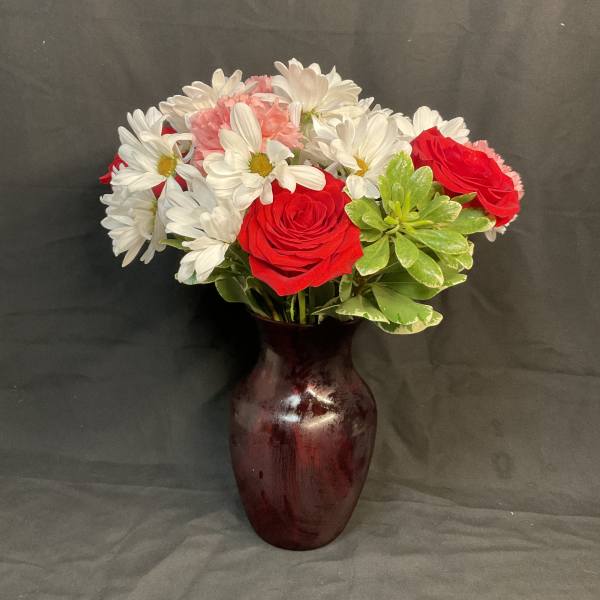Red roses and white daisies in a burgundy vase