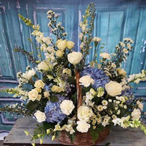 Large basket arrangement of white and blue flowers