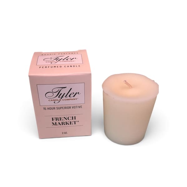 Pink boxed votive candle beside a cream candle