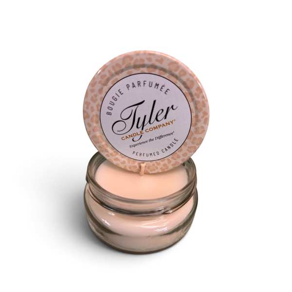 Pink scented candle in a glass jar with a matching lid