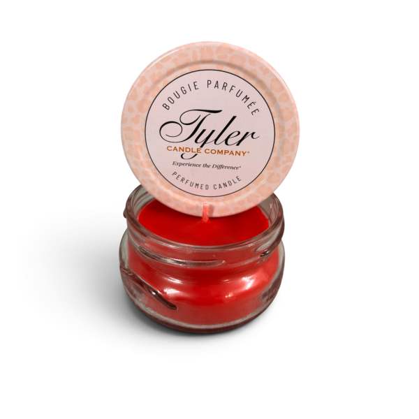 Red scented candle in a glass jar with a lid