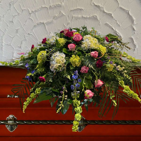 Large floral casket spray with pink roses and mixed blooms
