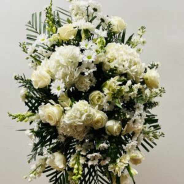 White floral standing spray with roses and daisies