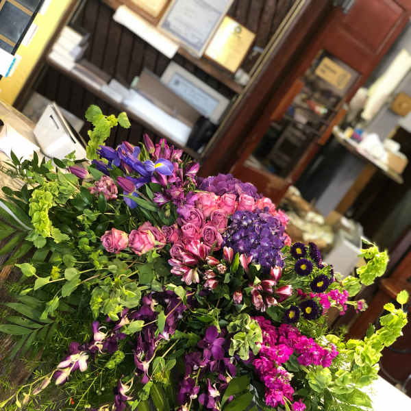 Large mixed bouquet with purple, pink, and green flowers