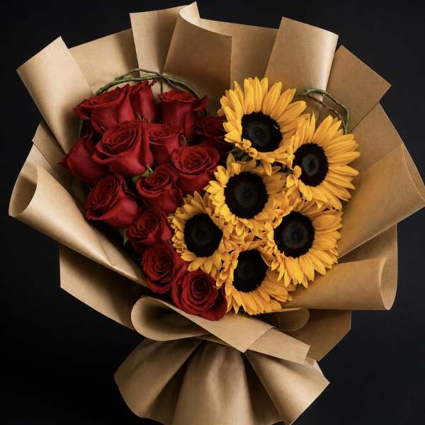 Bouquet of red roses and yellow sunflowers wrapped in brown paper