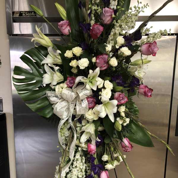 Tall standing floral spray with pink and white roses and lilies