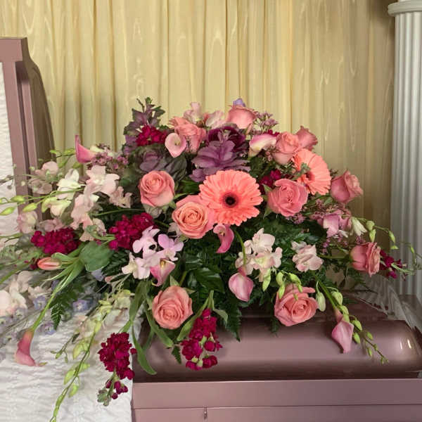 Pink and peach floral casket spray with roses and gerbera daisies