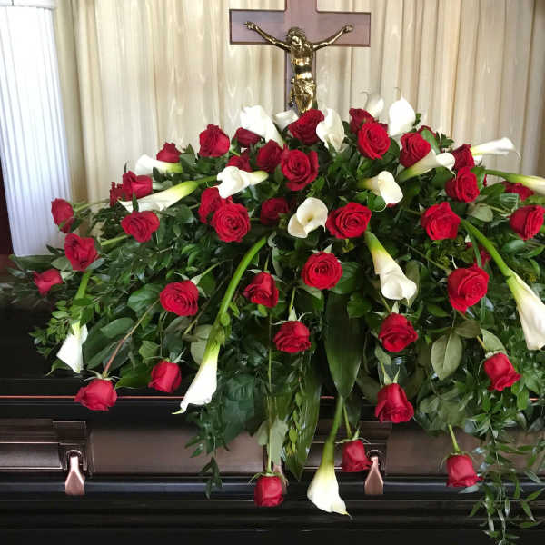 Casket spray of red roses and white calla lilies