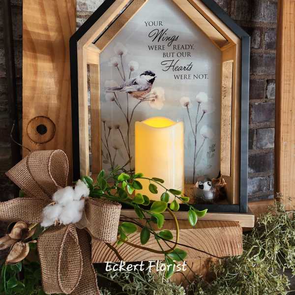 House-shaped memorial lantern with a bird print and glowing candle