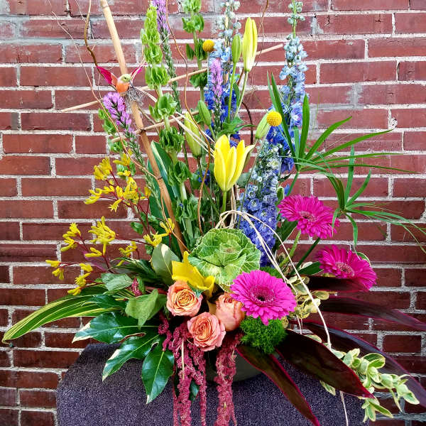 Tall mixed flower arrangement with pink gerberas, roses, and yellow lilies