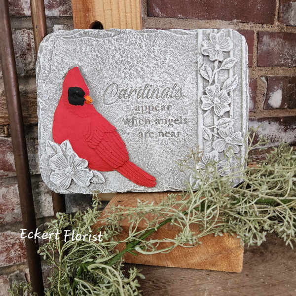 Decorative stone plaque with a red cardinal and floral accents
