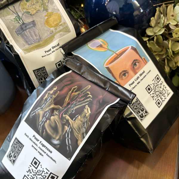 Three bags of packaged coffee beans with illustrated labels