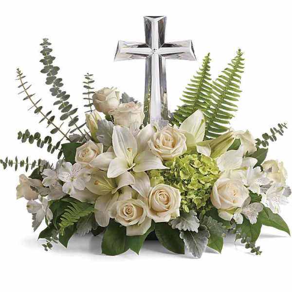White floral arrangement with a clear cross centerpiece