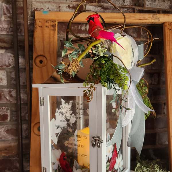 White lantern with red bird decoration and ribbon accents