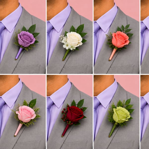 Boutonniere with a rose and greenery on a suit lapel