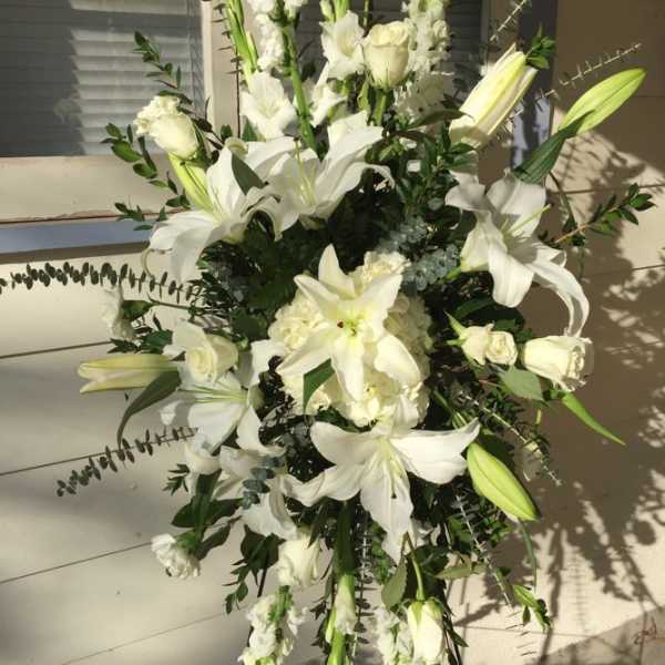 Tall white floral spray with lilies and roses