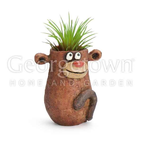 Cartoon monkey-shaped planter with a green plant on top