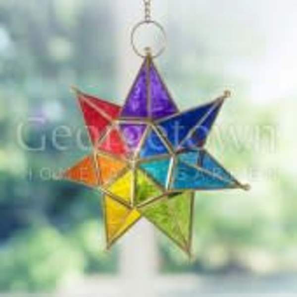 Rainbow-colored star ornament hanging against a blurred background