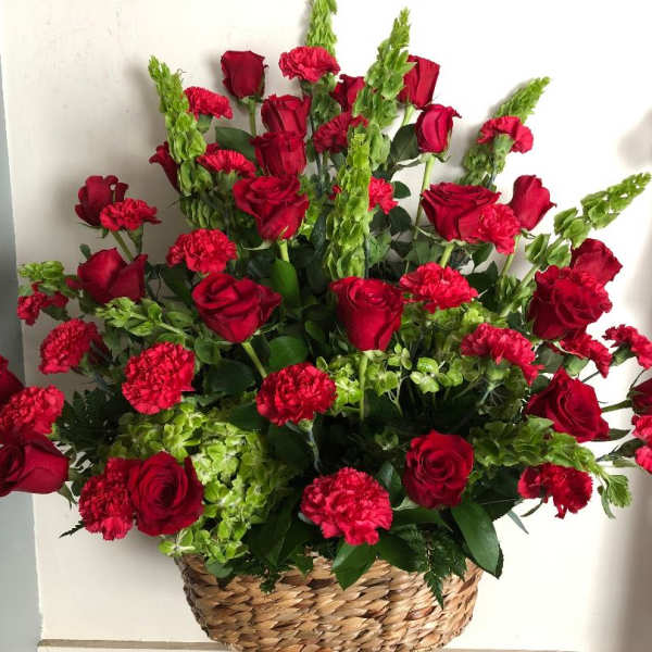 Basket arrangement of red roses and carnations