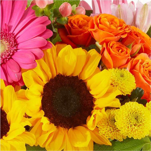 Bright mixed bouquet with a sunflower, pink gerbera, and orange roses