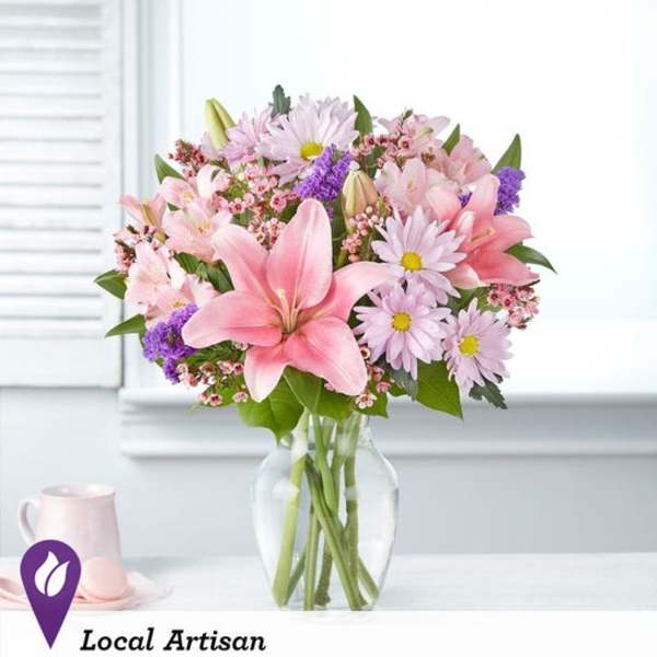 Pink and lavender mixed bouquet in a clear glass vase