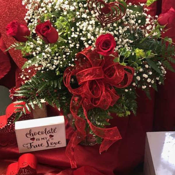 Red rose bouquet with baby's breath and a red ribbon bow