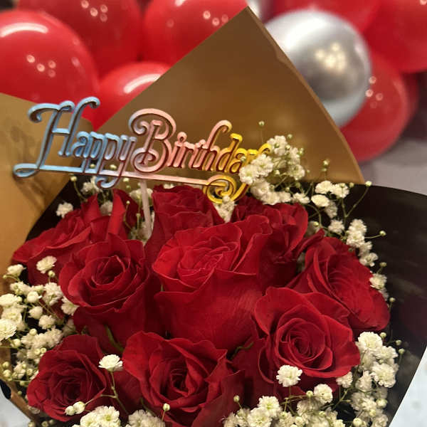 Bouquet of red roses with white baby's breath and a Happy Birthday topper